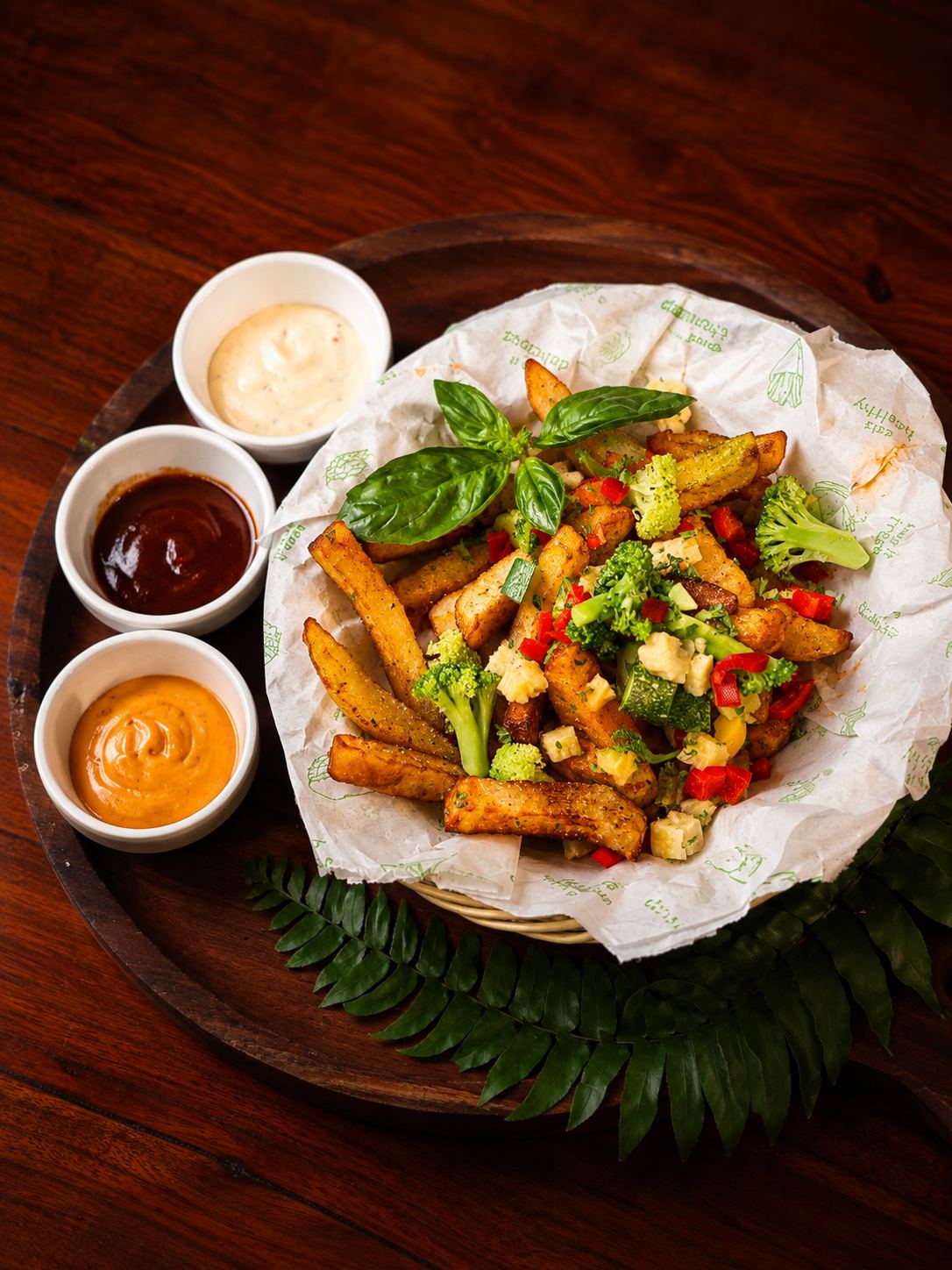 Loaded fries basket with dipping sauces, a late-night favorite at Open Crave Bunker